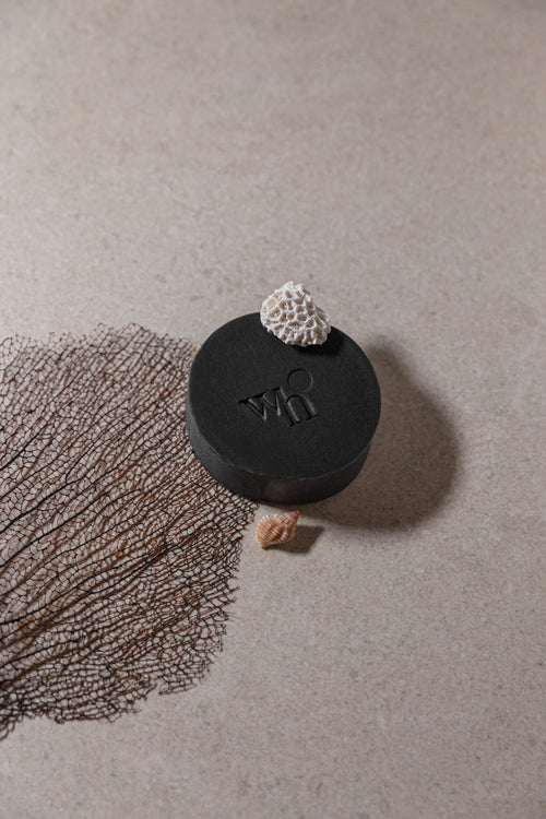 Black round activated charcoal handmade soap bar by Washo House, made in NYC for oily and acne-prone skin